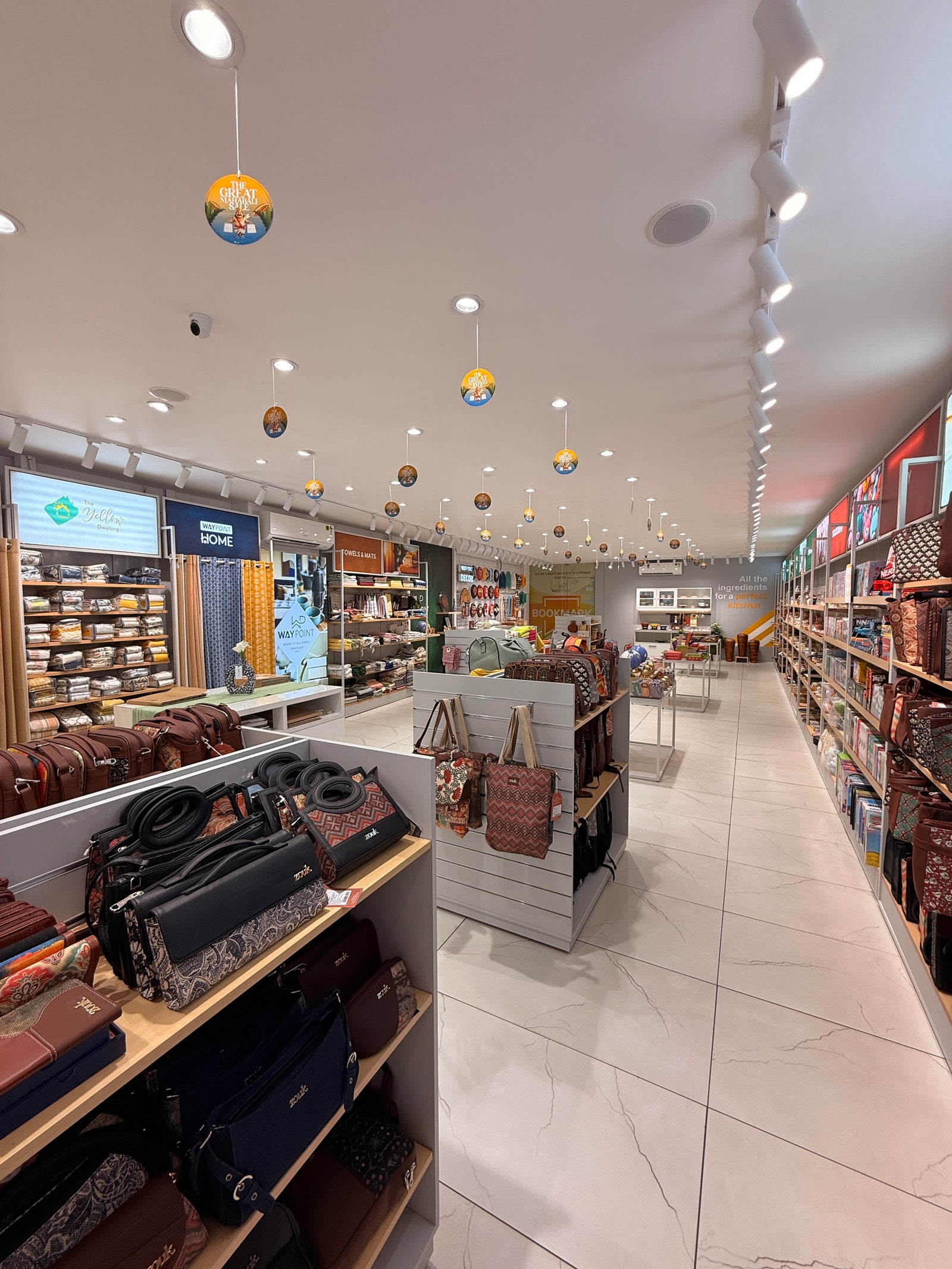 Long view down the aisle of Waypoint’s Kakkanad store, showing homeware and gift displays
