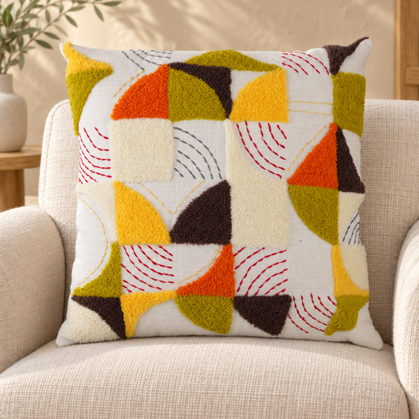 Colourful geometric tufted cushion on an ivory chair